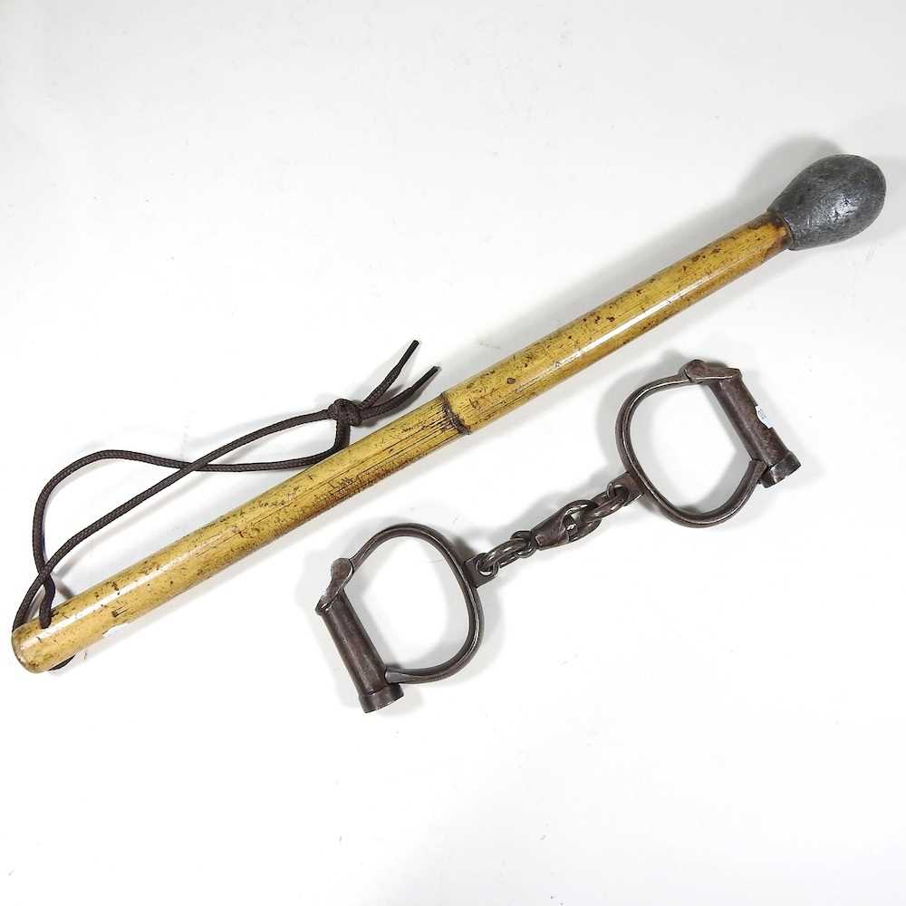 Lot 9 - A pair of antique handcuffs and baton