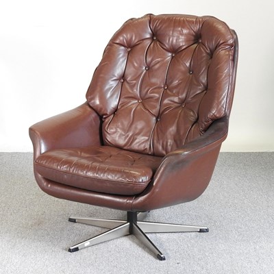 Lot 691 - A 1960's Danish brown leather swivel lounge...