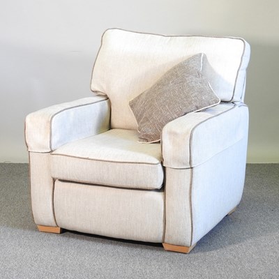 Lot 566 - A cream upholstered armchair