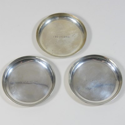 Lot 198 - A set of three silver coasters