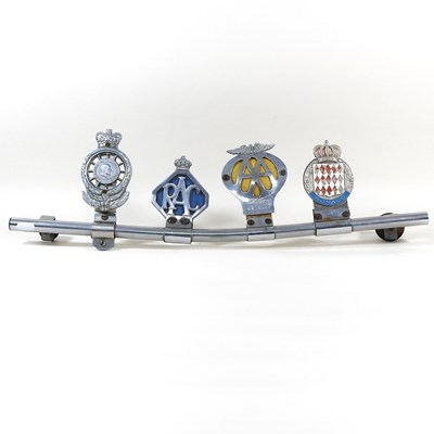 Lot 314 - A vintage car badge bar, displaying four badges