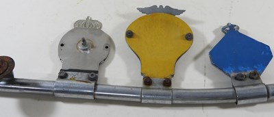 Lot 314 - A vintage car badge bar, displaying four badges