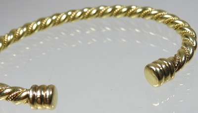 Lot 72 - An 18 carat gold bangle