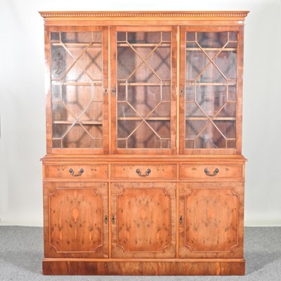 Lot 805 - A reproduction yew wood bookcase, on a plinth...