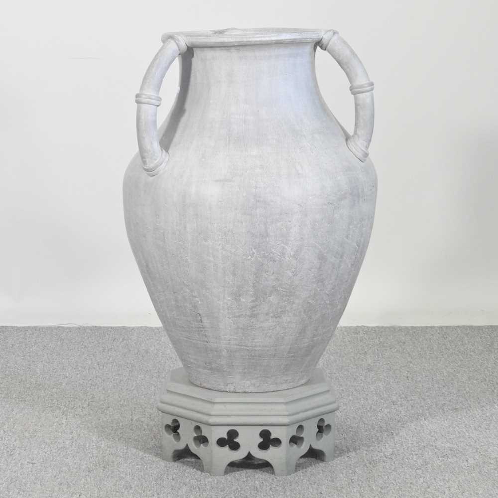 Lot 35 - A large glazed terracotta urn, on a wooden...