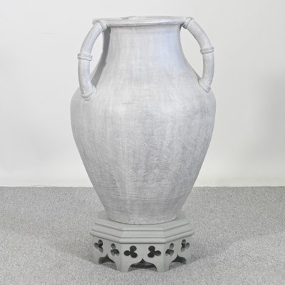 Lot 35 - A large glazed terracotta urn, on a wooden...