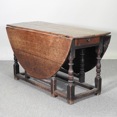 Lot 740 - An 18th century oak gateleg dining table, with...