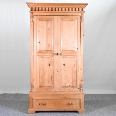 Lot 774 - A modern pine single wardrobe, with a drawer...