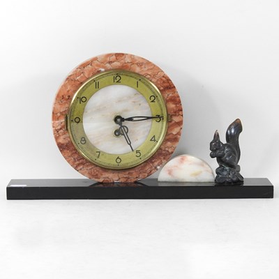 Lot 167 - An Art Deco marble mantel clock, surmounted by...