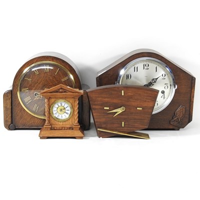 Lot 843 - A 1920's oak cased mantel clock, together with...