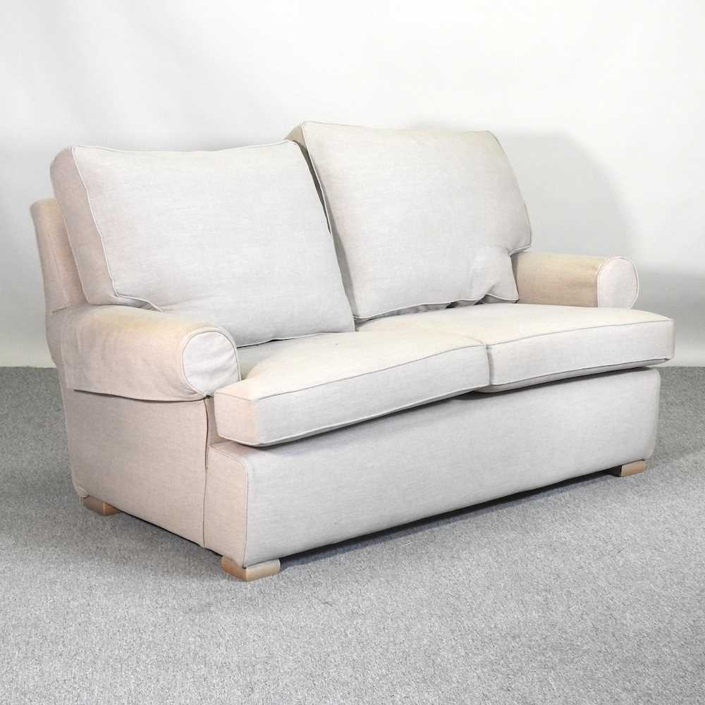 Lot 755 - A Multiyork cream upholstered two seater sofa