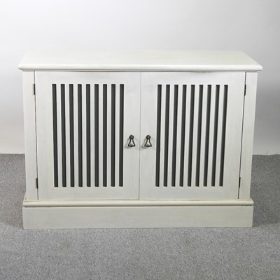 Lot 444 - A modern cream painted side cabinet, on a...