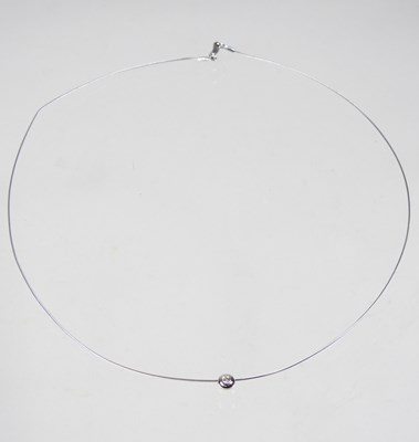 Lot 241 - An 18 carat white gold necklace, with a single...