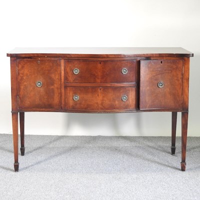 Lot 294 - A reproduction serpentine sideboard