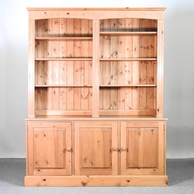 Lot 461 - A modern pine bookcase, with open shelves and...