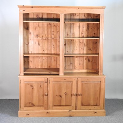 Lot 454 - A large pine bookcase, with open shelves and...