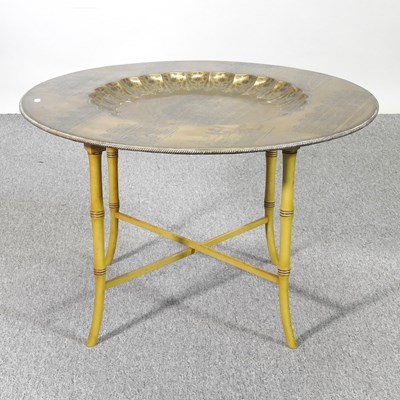 Lot 523 - An Indian brass tray top occasional table,...