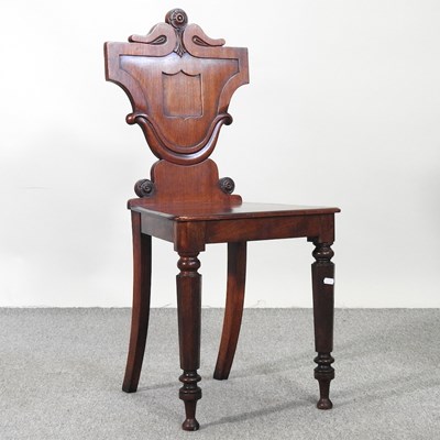 Lot 578 - A Regency carved mahogany hall chair, with a...