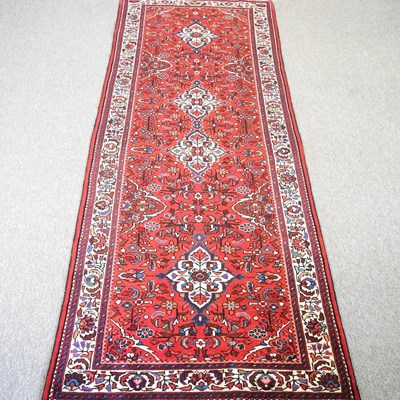 Lot 307 - A Persian runner, with floral designs, on a...