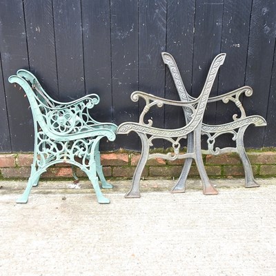 Lot 704 - A pair of iron bench ends, together with...