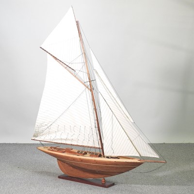 Lot 24 - A wooden model of a yacht, on stand, 115 x 131cm