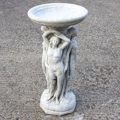 Lot 793 - A cast stone bird bath, with figural supports,...