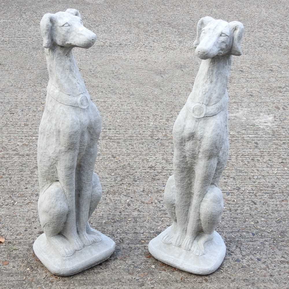 Lot 510 - A pair of cast stone garden statues of seated...