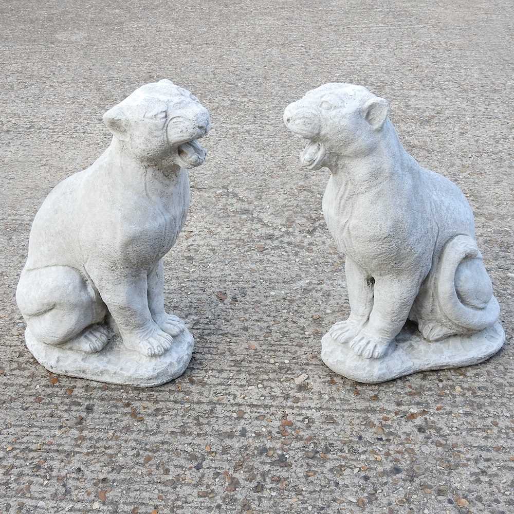 Lot 495 - A pair of cast stone garden statues of pumas,...