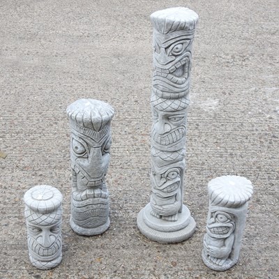 Lot 580 - Four cast stone garden statues of totem poles,...