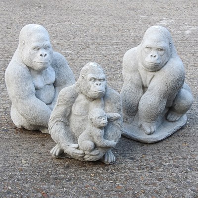 Lot 855 - Three cast stone garden models of gorillas,...