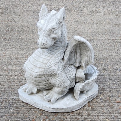 Lot 551 - A cast stone model of a seated dragon, 56cm high