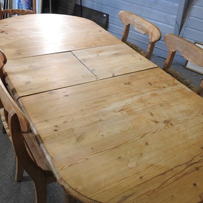 Lot 717 - A pine extending dining table, together with a...