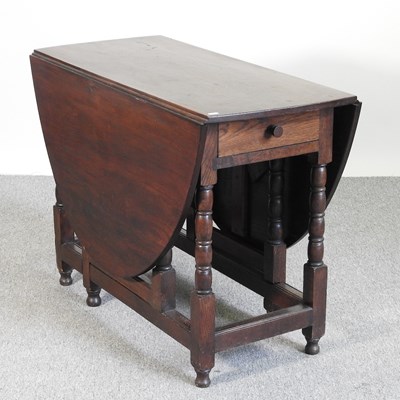 Lot 764 - A handmade oak gateleg dining table