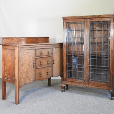 Lot 470 - A 1920's glazed oak bookcase, together with a...