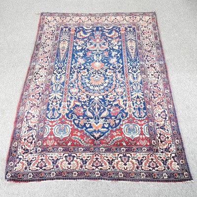 Lot 662 - A Persian rug, with foliate designs on a blue...