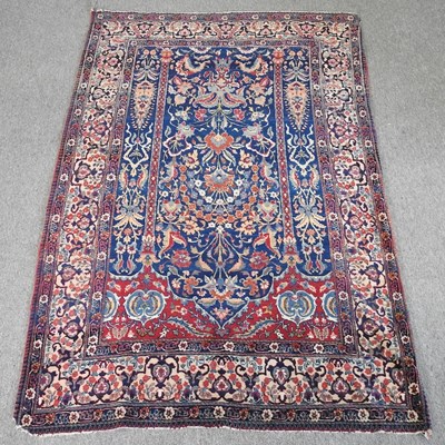 Lot 509 - A Persian woollen rug, with floral designs, on...