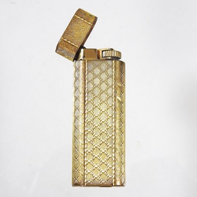 Lot 473 - A Cartier gold plated pocket lighter, with...