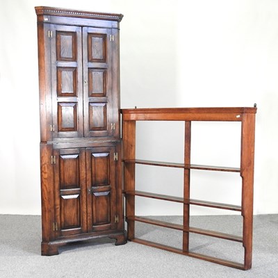 Lot 824 - A Georgian style oak standing corner cabinet,...