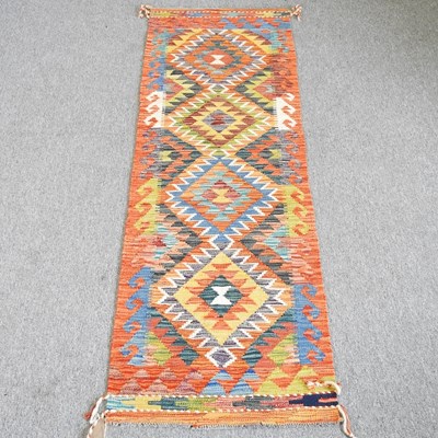 Lot 462 - A kilim runner, with a row of four central...