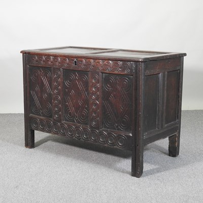 Lot 334 - An 18th century panelled oak coffer, with a...