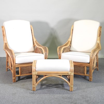 Lot 811 - A pair of rattan armchairs, with cream...