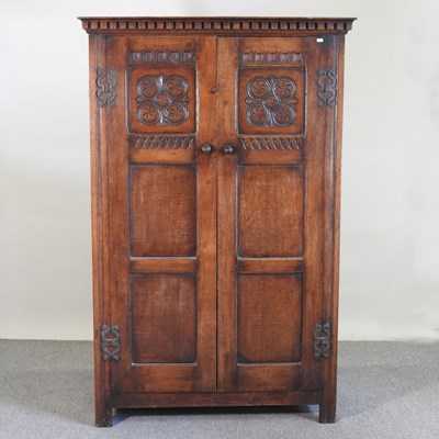 Lot 279 - An 18th century style carved oak cupboard,...