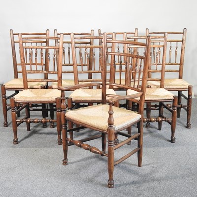 Lot 576 - A set of eight rush seated ladderback dining...