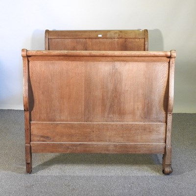 Lot 127 - An early 20th century French oak sleigh bed,...