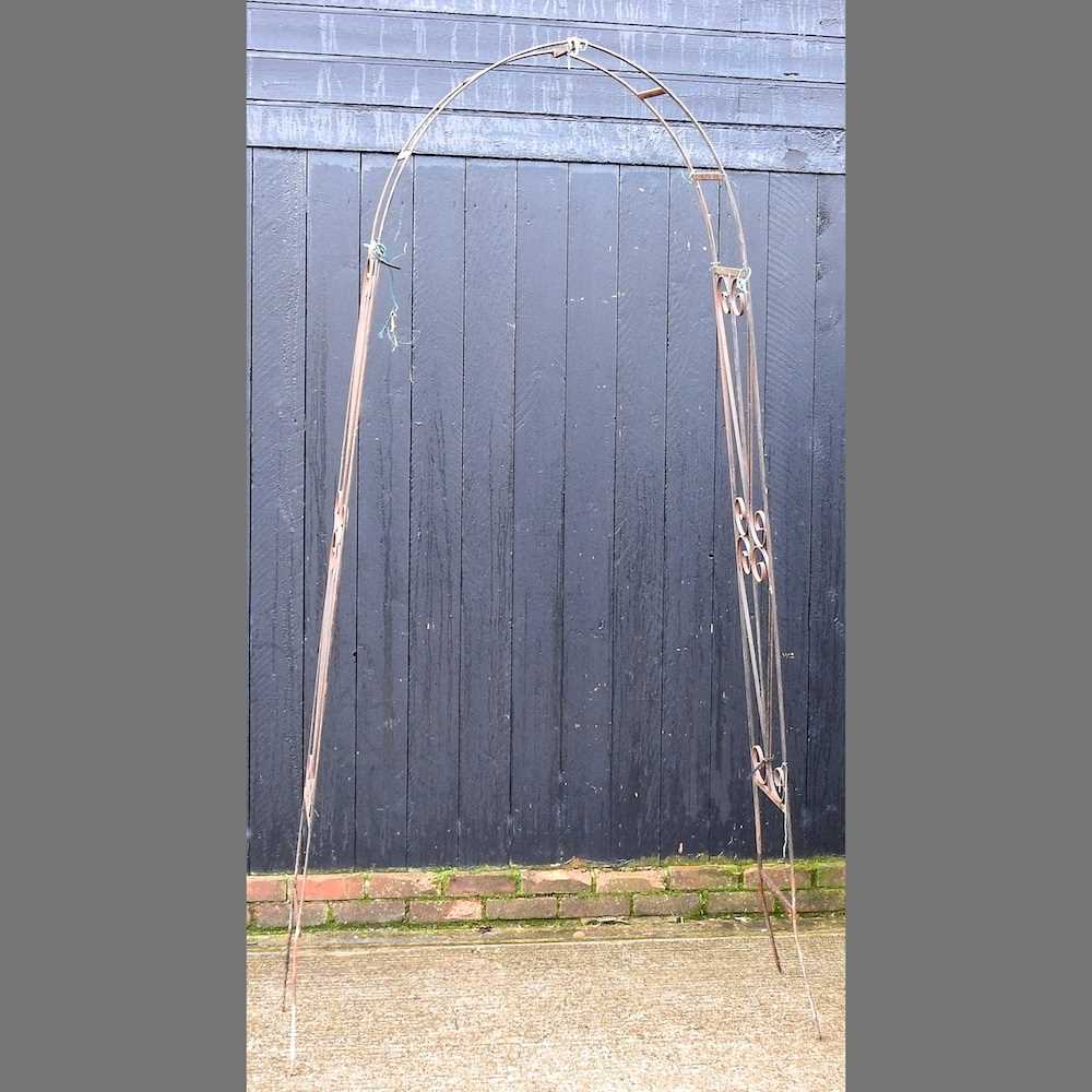 Lot 669 - A black painted wrought iron garden arch,...