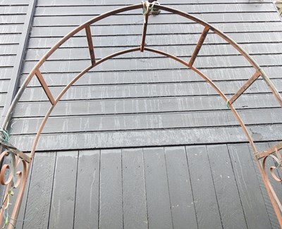 Lot 669 - A black painted wrought iron garden arch,...