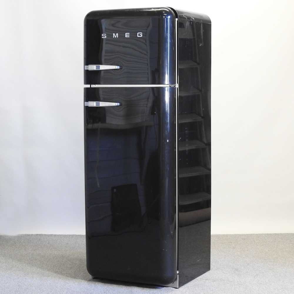 Lot 638 - A black Smeg fridge freezer