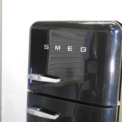 Lot 638 - A black Smeg fridge freezer