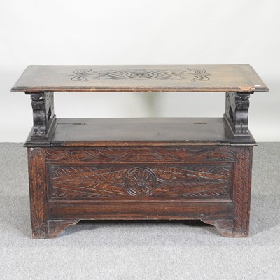 Lot 438 - An early 20th century carved oak monk's bench,...