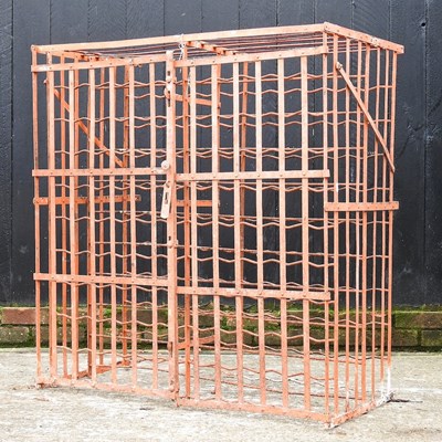 Lot 129 - A French iron wine rack, with hinged doors